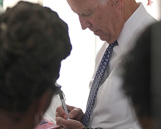 Nikos Frazier | The Vindicator..Vice President Joe Biden autographs a hat at the Canfield Fair on Thursday, Sept. 1, 2016.