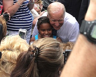 Nikos Frazier | The Vindicator..Vice President Joe Biden kneels down to take a photo with a child at the Canfield Fair on Thursday, Sept. 1, 2016.