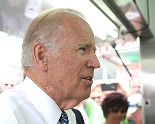 Nikos Frazier | The Vindicator..Vice President Joe Biden looks at the menu of Antones Concession at the Canfield Fair on Thursday, Sept. 1, 2016.