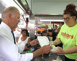 Nikos Frazier | The Vindicator..Vice President Joe Biden looks at the menu of Antones Concession at the Canfield Fair on Thursday, Sept. 1, 2016.