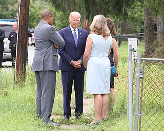 Nikos Frazier | The Vindicator..Vice President Joe Biden talks with members of the Mahoning Valley Land Bank(right) and former Youngstown Mayor, Jay Williams(left) at an empty lot on Glenaven Avenue in Youngstown, Oh. on Thursday, Sept. 1, 2016.