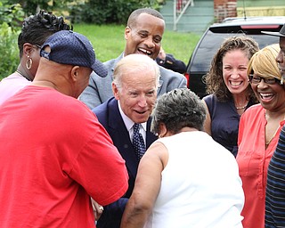 Nikos Frazier | The Vindicator..Vice President Joe Biden greets Glenaven Avenue residents while looking at a future site of Youngstown Neighborhood Development Corp homes.