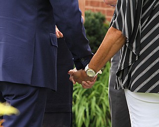 Nikos Frazier | The Vindicator..Vice President Joe Biden holds hands with a resident on Lanterman Ave. in Youngstown, Oh. on Thursday, Sept. 1, 2016.