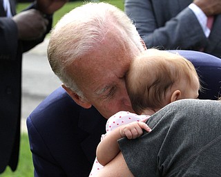 Nikos Frazier | The Vindicator..Vice President Joe Biden kisses a baby on Lanterman Ave. in Youngstown, Oh. on Thursday, Sept. 1, 2016.