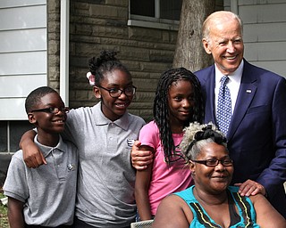 Nikos Frazier | The Vindicator..Vice President Joe Biden takes a photo with residents of Lanterman Ave. in Youngstown, Oh. on Thursday, Sept. 1, 2016.