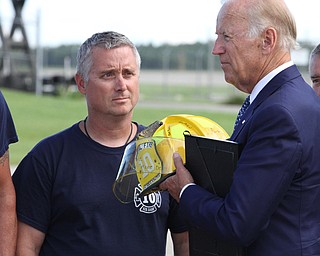 Nikos Frazier | The Vindicator..Vice President Joe Biden is presented with an autographed helmet by members of the YoungstownÐWarren Air Reserve Station Firefighters before departing the Air Station on Thursday, Sept. 1, 2016 after touring the Mahoning Valley.