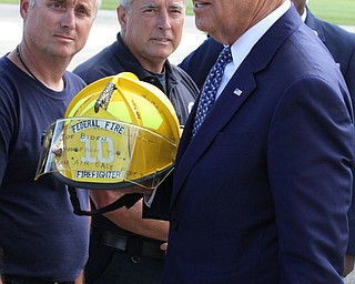 Nikos Frazier | The Vindicator..Vice President Joe Biden is presented with an autographed helmet by members of the YoungstownÐWarren Air Reserve Station Firefighters before departing the Air Station in Vienna, Oh. on Thursday, Sept. 1, 2016 after touring the Mahoning Valley.