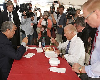        ROBERT K. YOSAY  | THE VINDICATOR...Dave Betras..  and Joe Biden start working on their meal at Antones Concession .. Ted Strickland is sitting down..Biden visits Canfield Fair... - -30-...