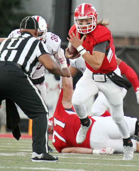 William D. Lewis/The Vindicator YSU QB Ricky Davis(12) scrambles fro 1rst qtr yardage during Sept. 1, 2016 game with Duquesne.09012016 wdl ysu a..
