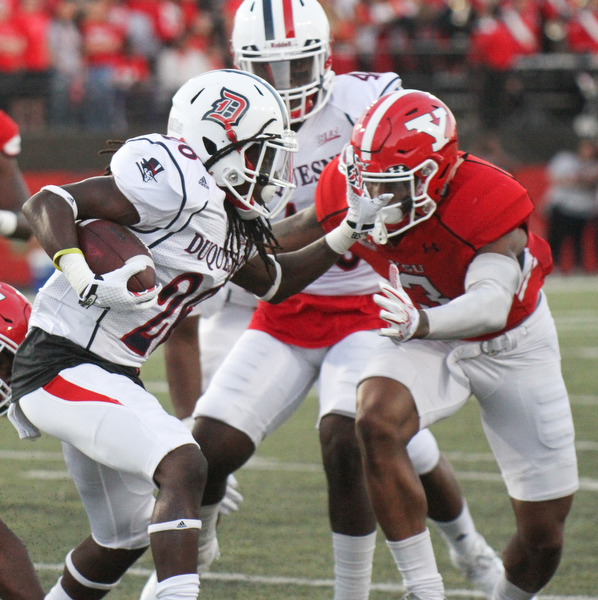 William D. Lewis/The Vindicator YSU Leroy Alexander(3)) stops Duquesne's Chayse Dillon(20) during 1rst qtr of Sept. 1, 2016 game with Duquesne