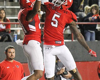 William D. Lewis/The Vindicator YSU Darien Townsend(21) gets hi 5 from Alvin Bailey(5) after scoring during 2nd qtr of Sept. 1, 2016 game with Duquesne