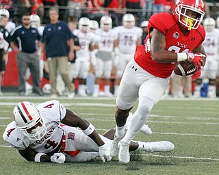 William D. Lewis/The Vindicator YSU Darien Townsend (21) eludes Duquesne defender Daquan Worley(4) to score during first qtr of Sept. 1, 2016 game with Duquesne