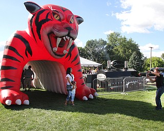Nikos Frazier | The Vindicator..Jim Loboy(right) takes a photo of his wife and daughter, Debra and Chloe, 4, infront of the Struthers Wildcat before walking into the tailgate party celebrating the 100-year anniversary of the Struthers football program.