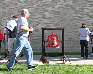 Nikos Frazier | The Vindicator..A man jogs past the Struthers Wildcat bell.