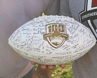 Nikos Frazier | The Vindicator..Travis Stocker, Struthers High School Class of 1990, holds a 100-year anniversary commemorative football at the Laddie J. Fedor Field.