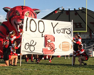 Nikos Frazier | The Vindicator..Struthers High School Cheerleaders hold a "100 years of Wildcat Football" banner before the Struthers Football team stampedes through.