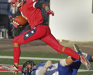 William D. Lewis/The Vindicator Niles Tre Martin (4) scampers over Poland's Reid Gould(2) to score early in Friday Sept. 2, 2016 game at Niles.