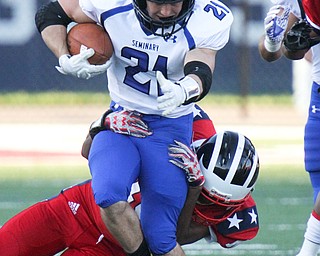 William D. Lewis/The Vindicator Poland's Dante Romano(21) is tackled by Tyreek Faison(10) of Niles during Friday Sept. 2, 2016 game at Niles.