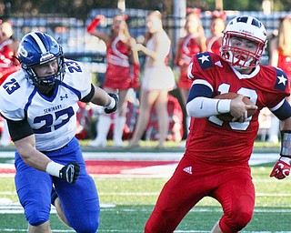 William D. Lewis/The Vindicator Niles Tyler Srbinovich(13) scamperspast Poland's Alec Catsoules(23) during Friday Sept. 2, 2016 game at Niles.