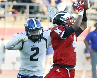 William D. Lewis/The Vindicator Niles Tre Martin (4) pulls in a pass as Poland's Reid Gould(2) defends  in Friday Sept. 2, 2016 game at Niles.