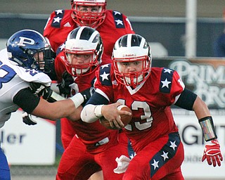 William D. Lewis/The Vindicator Niles Tyler Srbinovich(13 picks up 2nd qtr yardage while trying to elude Poland's Alec Catsoules)  in Friday Sept. 2, 2016 game at Niles.
