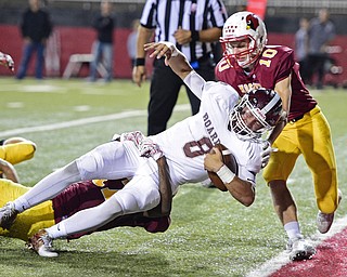 YOUNGSTOWN, OHIO - SEPTEMBER 2, 2016: Quarterback Mike O'Horo #8 of Boardman drags Darrell Jackson #17 of Mooney across the goal line to score a touchdown, before being hit by Pat Pelini #10, during the second half of their game Friday night at Stambaugh Stadium. DAVID DERMER | THE VINDICATOR