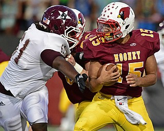 YOUNGSTOWN, OHIO - SEPTEMBER 2, 2016: Quarterback Antonio Page #15 of Mooney runs the football while avoiding the arm tack from Evan Walton #61 of Boardman during the first half of their game Friday night at Stambugh Stadium. DAVID DERMER | THE VINDICATOR