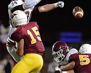 YOUNGSTOWN, OHIO - SEPTEMBER 2, 2016: Quarterback Antonio Page #15 of Mooney has his pass knocked down by Gaven Strines #34 of Boardman during the first half of their game Friday night at Stambugh Stadium. DAVID DERMER | THE VINDICATOR