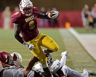 YOUNGSTOWN, OHIO - SEPTEMBER 2, 2016: Running back Jaylen Hewlett #9 of Mooney turns upfield to run over Travis Koontz #10 and Gaven Strines #34 of Boardman during the second half of their game Friday night at Stambaugh Stadium. DAVID DERMER | THE VINDICATOR