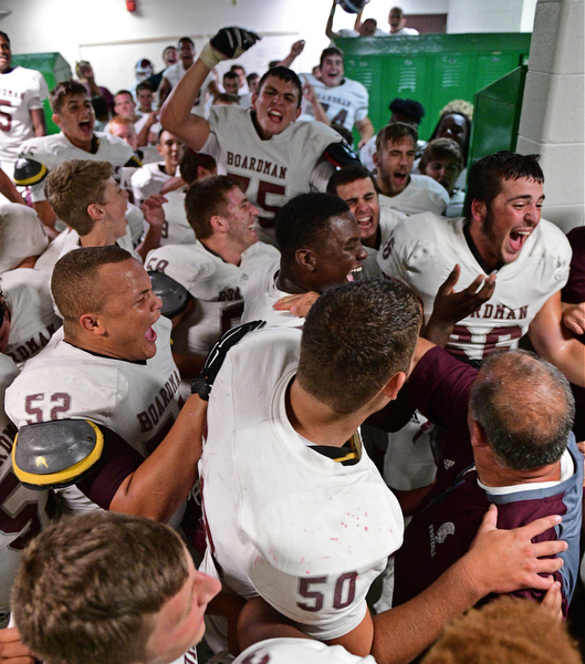 YOUNGSTOWN, OHIO - SEPTEMBER 2, 2016: Boardman players and coaches celebrate in their locker room following their 28-26 victory over Cardinal Mooney at Stambaugh Stadium. DAVID DERMER | THE VINDICATOR