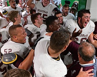 YOUNGSTOWN, OHIO - SEPTEMBER 2, 2016: Boardman players and coaches celebrate in their locker room following their 28-26 victory over Cardinal Mooney at Stambaugh Stadium. DAVID DERMER | THE VINDICATOR