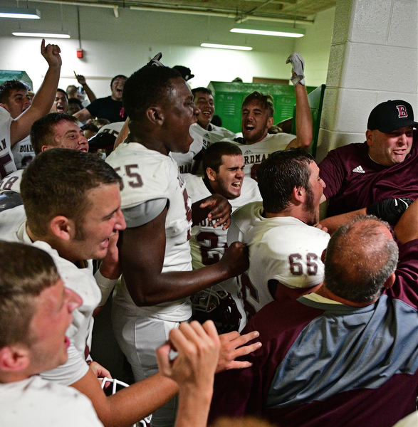 YOUNGSTOWN, OHIO - SEPTEMBER 2, 2016: Boardman players and coaches celebrate in their locker room following their 28-26 victory over Cardinal Mooney at Stambaugh Stadium. DAVID DERMER | THE VINDICATOR