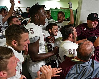 YOUNGSTOWN, OHIO - SEPTEMBER 2, 2016: Boardman players and coaches celebrate in their locker room following their 28-26 victory over Cardinal Mooney at Stambaugh Stadium. DAVID DERMER | THE VINDICATOR