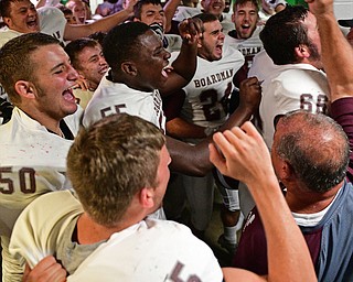YOUNGSTOWN, OHIO - SEPTEMBER 2, 2016: Boardman players and coaches celebrate in their locker room following their 28-26 victory over Cardinal Mooney at Stambaugh Stadium. DAVID DERMER | THE VINDICATOR