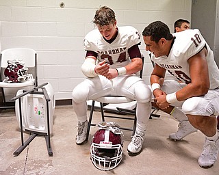 YOUNGSTOWN, OHIO - SEPTEMBER 2, 2016: Gaven Strines #34 (left) and Travis Koontz #10 of Boardman smile in the locker room following their 28-26 victory over Cardinal Mooney at Stambaugh Stadium. DAVID DERMER | THE VINDICATOR