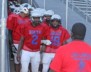 Michael Lawrence (2) and Leon Bell (19) of Youngstown East lock arms as they lead the Panthers onto the field prior to the start of their matchup against Ursuline at Rayen Field in Youngstown. Dustin Livesay  |  The Vindicator  9/2/16  Rayen Stadium