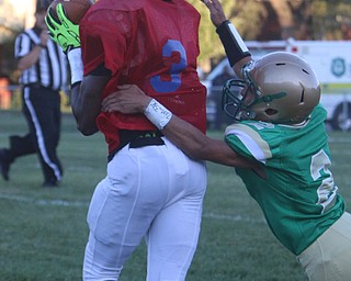 Youngstown East's Michael Ramey (3) catches a pass while being defended by Ursuline's  Anise Algahmee (2) during the first quarter of Friday nights matchup at Rayen Field in Youngstown. Dustin Livesay  |  The Vindicator  9/2/16  Rayen Stadium