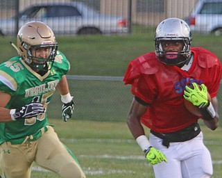 Youngstown Eat's Michael Ramey (3) outruns Mario Fusillo (45) to the corner during the second quarter of Friday nights matchup at Rayen Field in Youngstown. Dustin Livesay  |  The Vindicator  9/2/16  Rayen Stadium