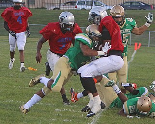 Youngstown East's Michael Ramey gets hit hard out of bounds by Ursuline's Daylen Harris (1) during the second quarter of Friday nights matchup at Rayen Field in Youngstown. Dustin Livesay  |  The Vindicator  9/2/16  Rayen Stadium