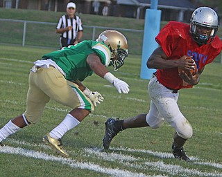 Youngstown East's Michael Lawrence (2) braces for the hit by Ursuline's Daylen Harris (1) during the first quarter of Friday nights matchup at Rayen Field in Youngstown. Dustin Livesay  |  The Vindicator  9/2/16  Rayen Stadium, Youngstown