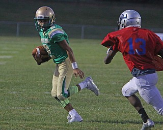 Ursuline's Anise Algahmee (2) tries to get the corner around Youngstown East's Mark Herron Jr. (13) during the second quarter of Friday nights matchup at Rayen Field in Youngstown. Dustin Livesay  |  The Vindicator  9/2/16  Rayen Stadium