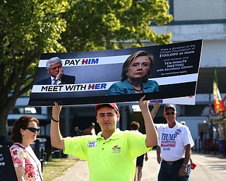 Nikos Frazier | The Vindicator..A Trump supporter walks towards the Mahoning County Democratic Party Tent at the Canfield Fair on Monday, Sept. 5, 2016.