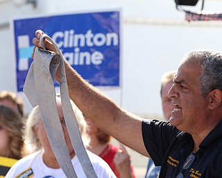 Nikos Frazier | The Vindicator..David Betras, Mahoning County Democratic Chairman, holds up a Trump Tie made in China at a press conference outside the Mahoning County Democratic Party Tent at the Canfield Fair on Monday, Sept. 5, 2016.