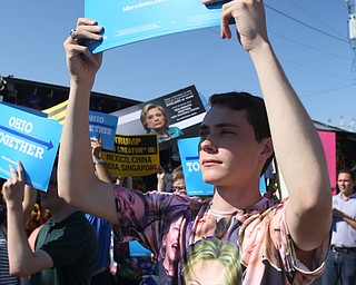Nikos Frazier | The Vindicator..Danny Hastings of Geneva, N.Y., holds a "Ohio Together" sign at a press conference outside the Mahoning County Democratic Party Tent at the Canfield Fair on Monday, Sept. 5, 2016.