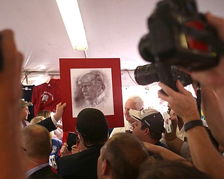 Canfield, Ohio | September 5, 2016: ..Republican presidential candidate Donald Trump autographs a portrait of himself from a local supporter while inside the Mahoning Country Republican Party tent during a stop to the 170th Canfield Fair on Monday, Sept. 5, 2016 in Canfield, Ohio...Nikos Frazier | The Vindicator.