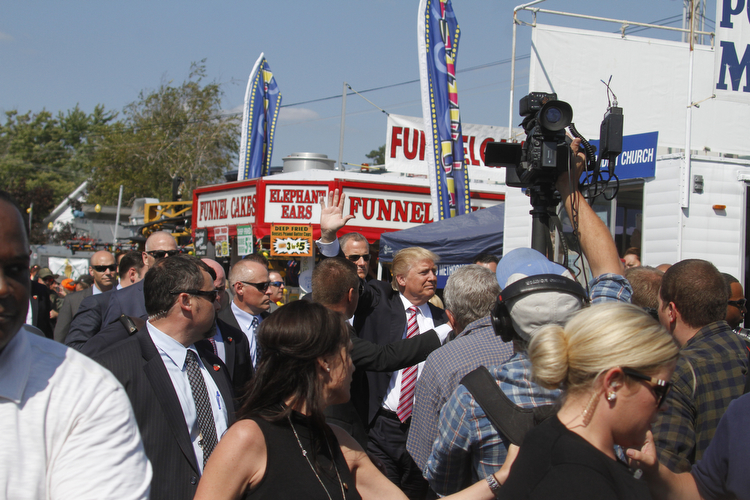  .          ROBERT  K. YOSAY | THE VINDICATOR..The Donald is surrounded by  security as he makes his way down the midway..crowds 7-9000 people   waited to see THE DONALD as he made his way to the Republican tent..Donald Trump... visitedthe Canfield Fair on Monday afternoon..-30-
