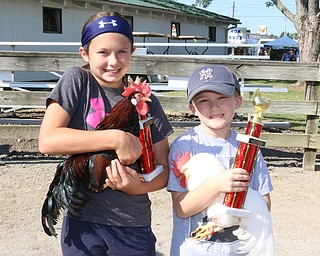 Luca Aurilio (7,right) won first place in the Rooster Crowing Contest and his sister Ava Aurilio (11) took home second place during the Rooster Crowing Contest at the Canfield Fair on Monday morning.  Dustin Livesay  |  The Vindicator  9/5/16  Canfield Fairgrounds.