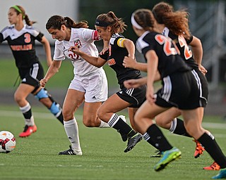 CANFIELD, OHIO - SEPTEMBER 7, 2016: Angela Copploe #32 of Canfield battles with Sara Ciletti #9 of Howland for the ball while being chased by several other Howland defenders in the first half of their game Wednesday night at Canfield High School. DAVID DERMER | THE VINDICATOR