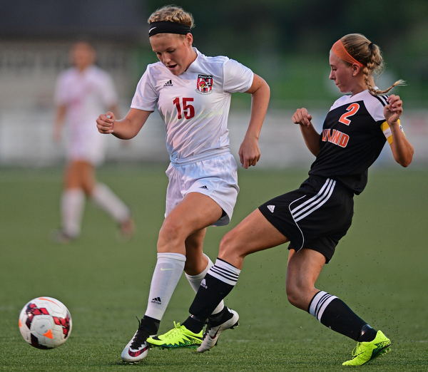 CANFIELD, OHIO - SEPTEMBER 7, 2016: Chloe Kalina #15 of Canfield has the ball kicked away from her by Izzy Albrecht #2 of Howland in the first half of their game Wednesday night at Canfield High School. DAVID DERMER | THE VINDICATOR