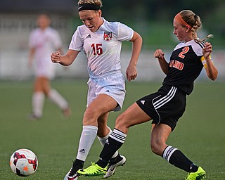 CANFIELD, OHIO - SEPTEMBER 7, 2016: Chloe Kalina #15 of Canfield has the ball kicked away from her by Izzy Albrecht #2 of Howland in the first half of their game Wednesday night at Canfield High School. DAVID DERMER | THE VINDICATOR